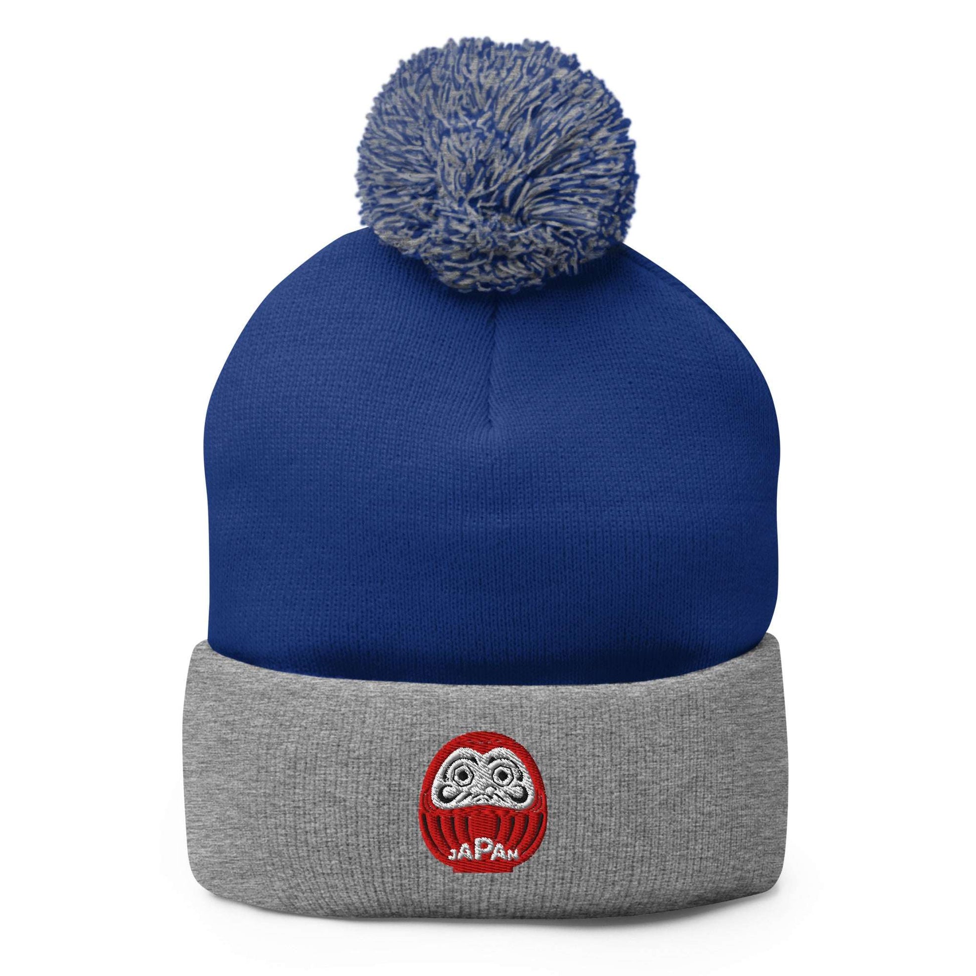 Japan-Daruma Lucky Charm pom-pom beanie by Aymar Quiris Studio, blue and grey two-tone unisex winter hat with Japanese Daruma art.