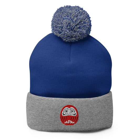 Japan-Daruma Lucky Charm pom-pom beanie by Aymar Quiris Studio, blue and grey two-tone unisex winter hat with Japanese Daruma art.